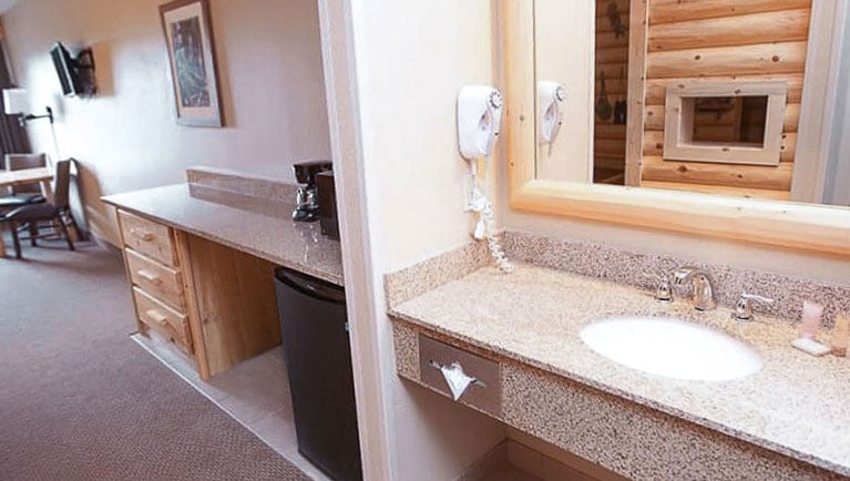 The sink and mini-fridge in the  accessible bathtub Junior Cabin Suite